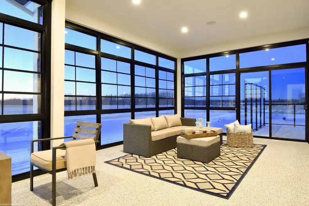 Sunroom featuring black-framed WeatherMaster™ vertical windows and matching sliding door.